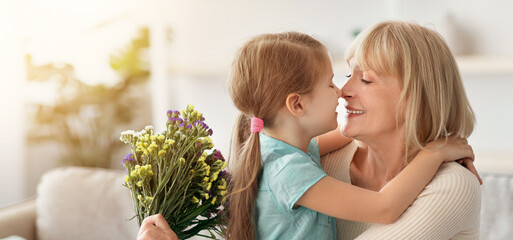 Birthday Present. Cheerful granddaughter greeting happy senior lady woman with holiday, presenting...