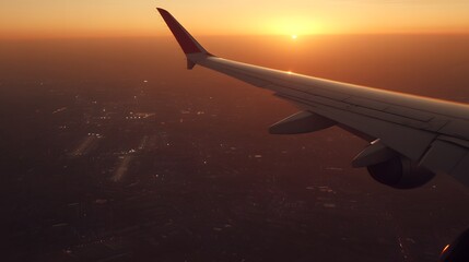 Fototapeta premium Stunning Sunset Aerial View Airplane Wing Over Cityscape