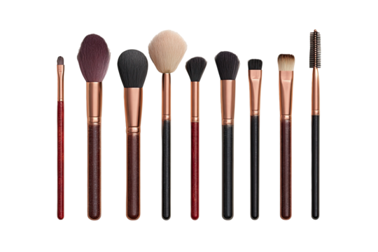Row of makeup brushes with copper-toned handles.  Various brush shapes and sizes.  Black,  copper, and reddish brown shades
