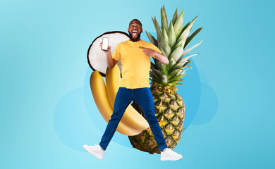 A joyful individual holds a smartphone while surrounded by colorful fruits like pineapple and...