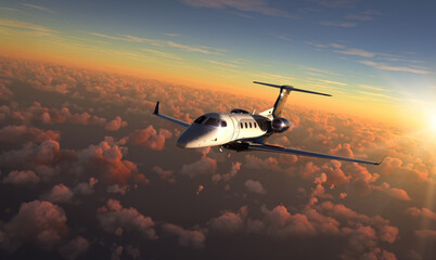 Private Jet flying over amazing sunset