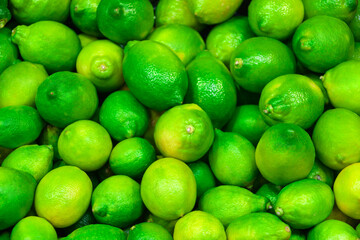 Fresh green lime lemon in the shelf at the store for sale, harvest season freshly picked from a farm