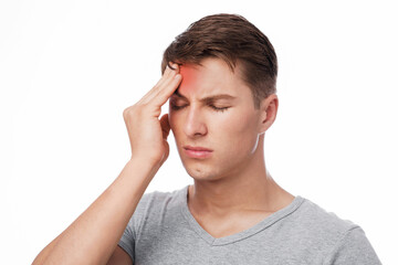 Despaired sad attractive young caucasian guy suffering from headache, touching forehead, isolated...
