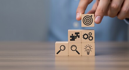 Hand stacking wooden cubes with business icons forming a staircase business strategy success