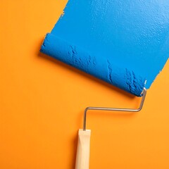 Obraz premium Paint roller on orange wall (1)