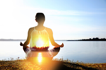 Practicing yoga in nature. Woman meditating in lotus position on river shore. Double exposure with...