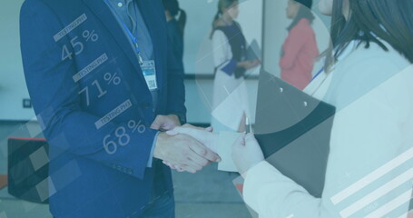 Shaking hands business associates at conference room, with clipboard and data charts overlay