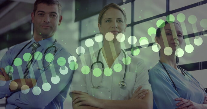 Standing three staff wearing scrubs and tie in medical lobby, with stethoscopes and DNA overlay - Powered by Adobe