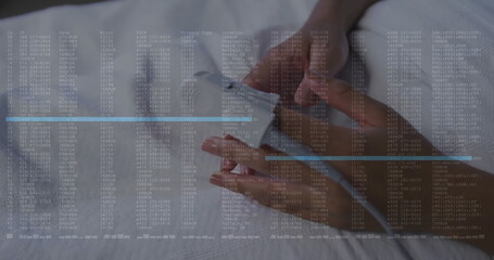 Tearing and applying white bandage to index finger on exam table with code overlay, copy space