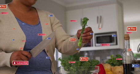Woman wearing cardigan holding chef's knife and broccoli in kitchen, with overlay icons, copy space