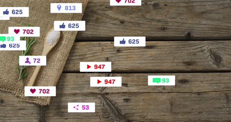 Wooden spoon carrying salt, rosemary sprig on burlap tabletop with social media icons, copy space