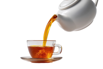 Hot tea is poured from a white teapot into a clear glass cup.  A stream of amber liquid flows