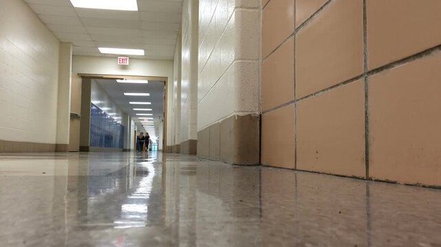 Two kids walking down school hallway