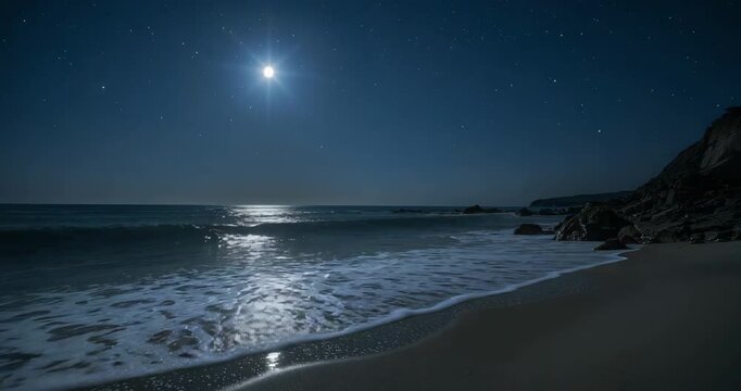 Full moonlit waves washing over wet sand, breaking under stars receding past rocky outcrop  and  cli
