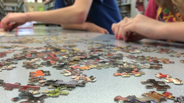 Kids building puzzle in library