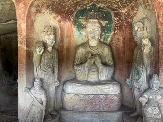 Statues of Buddha, Bodhisattvas and guardian warriors in Central-Pillar Grotto at Thousand-Buddha Cliff in Guangyuan, Sichuan, China, constructed from late Northern Wei Dynasty.