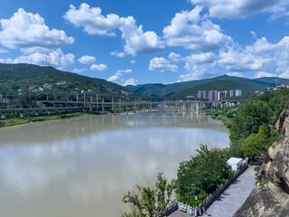 Jialing River, bridges, mountains from historical Thousand-Buddha Cliff on eastern bank in Guangyuan, Sichuan, China.