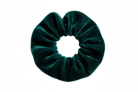 Emerald green velvet scrunchie displaying luxurious texture, highlighting soft fabric and contemporary hair accessory styling against clear backdrop