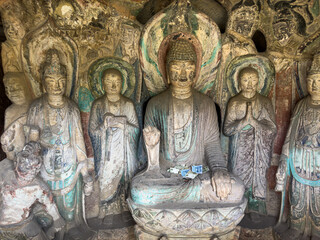 Statues of Buddha, Disciples, Bodhisattvas in Thousand-Buddha Grotto at Thousand-Buddha Cliff along bank of Jialing River in Guangyuan, Sichuan, China, constructed from late Northern Wei Dynasty.