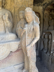Symbolic statue of lotus holding Avalokitesvara or Guanyin in Prabhutaratna Grotto at Thousand-Buddha Cliff in Guangyuan, Sichuan, China, constructed from late Northern Wei Dynasty.