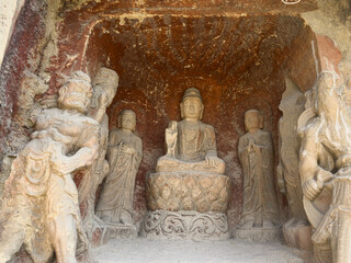 Statues of Buddha, Disciples, Bodhisattvas, guardian warriors in a grotto at Thousand-Buddha Cliff along bank of Jialing River in Guangyuan, Sichuan, China, constructed from late Northern Wei Dynasty.