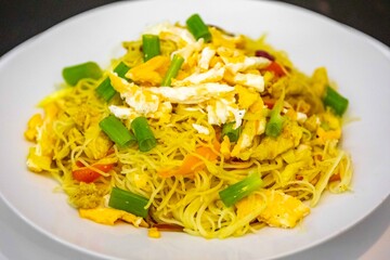 Traditional rice noodles with curry, chicken and vegetables