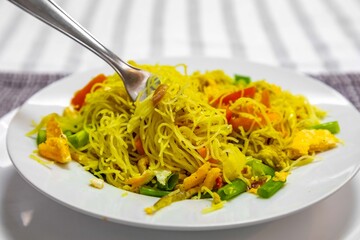 Traditional rice noodles with curry, chicken and vegetables