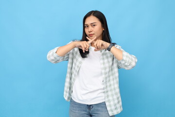 Portrait of unhappy young Asian woman, showing hand gestures of stop, prohibit, protest, crossed...