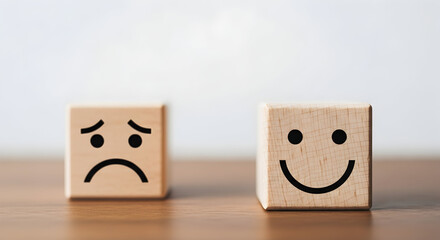 Understanding the difference between happiness and sadness concept with wooden blocks emotions face