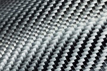 Close-up photo of the surface of carbon fiber fabric.