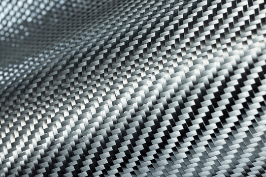 Close-up photo of the surface of carbon fiber fabric.