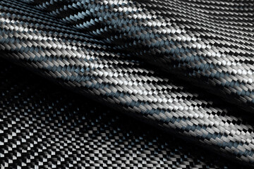 Close-up photo of the surface of carbon fiber fabric.