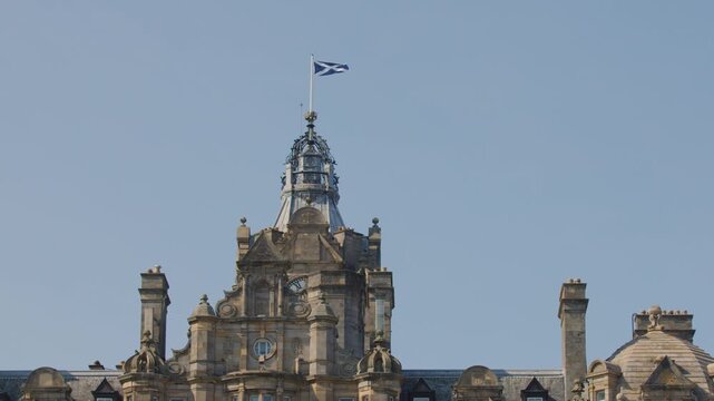 Scottish Flag Waving Atop Historic Edinburgh Building