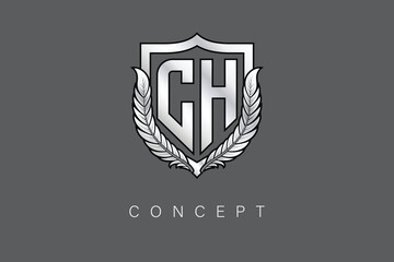 CH Creative Initial Letter Logo with Shield and Laurel Wreath Silver Metallic Branding Emblem on Gray Background.