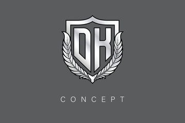 DK Creative Initial Letter Logo with Shield and Laurel Wreath Silver Metallic Branding Emblem on Gray Background.
