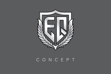 EQ Creative Initial Letter Logo with Shield and Laurel Wreath Silver Metallic Branding Emblem on Gray Background.