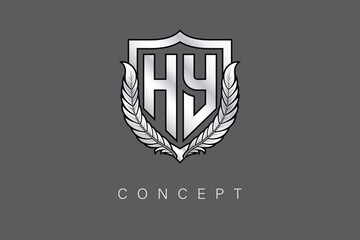 Obraz premium HY Creative Initial Letter Logo with Shield and Laurel Wreath Silver Metallic Branding Emblem on Gray Background.