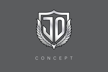 Obraz premium JO Creative Initial Letter Logo with Shield and Laurel Wreath Silver Metallic Branding Emblem on Gray Background.