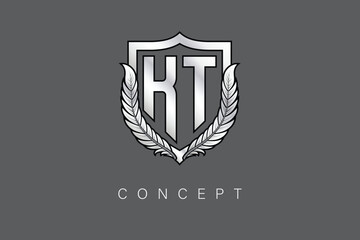 KT Creative Initial Letter Logo with Shield and Laurel Wreath Silver Metallic Branding Emblem on Gray Background.