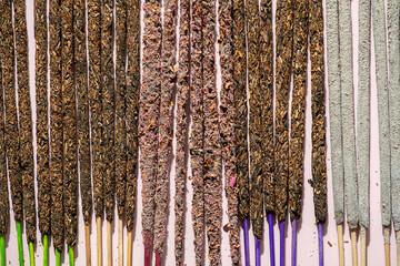 Variety of handmade incense sticks with colorful bases