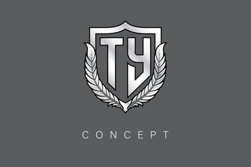 TY Creative Initial Letter Logo with Shield and Laurel Wreath Silver Metallic Branding Emblem on Gray Background.