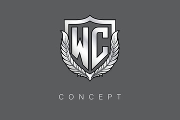 WC Creative Initial Letter Logo with Shield and Laurel Wreath Silver Metallic Branding Emblem on Gray Background.