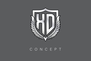 XD Creative Initial Letter Logo with Shield and Laurel Wreath Silver Metallic Branding Emblem on Gray Background.
