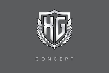 XG Creative Initial Letter Logo with Shield and Laurel Wreath Silver Metallic Branding Emblem on Gray Background.