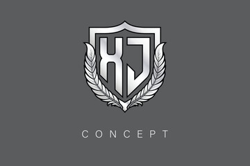 XJ Creative Initial Letter Logo with Shield and Laurel Wreath Silver Metallic Branding Emblem on Gray Background.