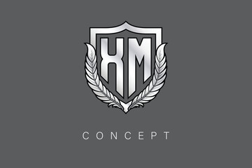 XM Creative Initial Letter Logo with Shield and Laurel Wreath Silver Metallic Branding Emblem on Gray Background.
