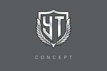 YT Creative Initial Letter Logo with Shield and Laurel Wreath Silver Metallic Branding Emblem on Gray Background.