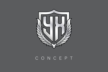 YX Creative Initial Letter Logo with Shield and Laurel Wreath Silver Metallic Branding Emblem on Gray Background.