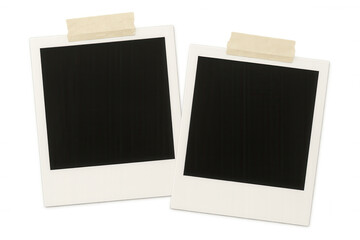 Pair of blank instant photo prints affixed to a clear surface using adhesive tape, offering a customizable and retro-inspired setting
