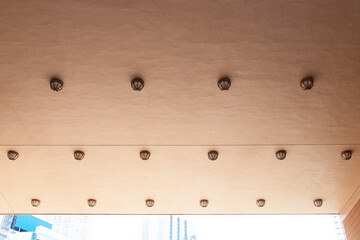 Ceiling light brown with light bulb and sky. Roof smooth gypsum board ceiling. Office building...